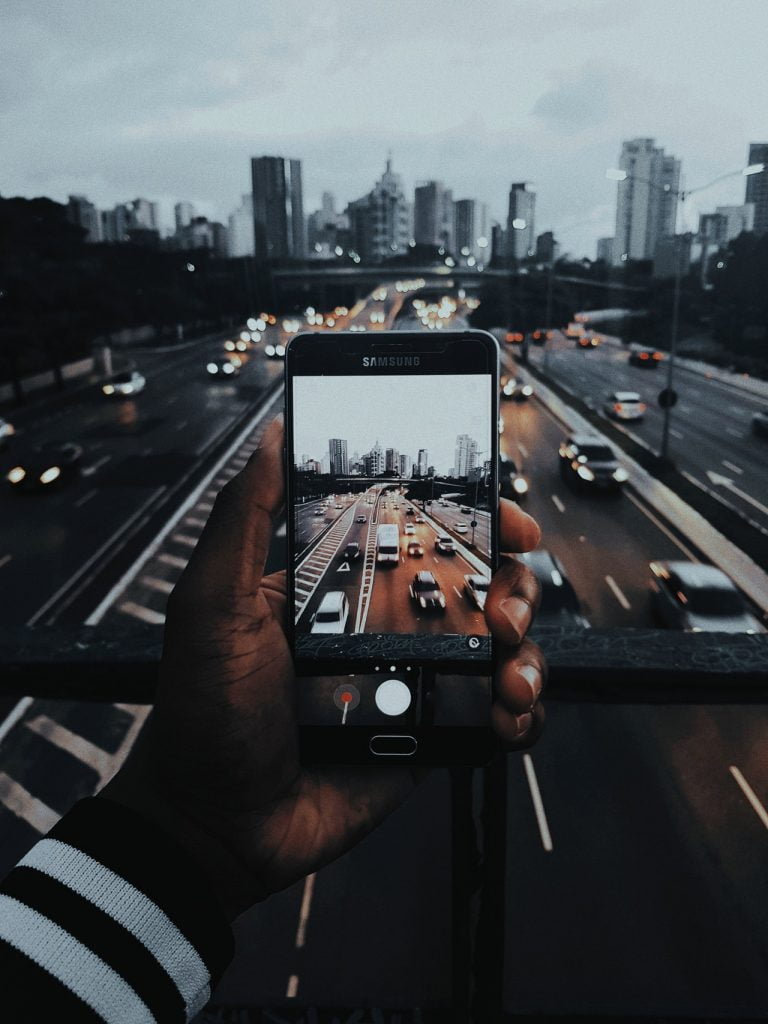 a person holding a phone up to their face