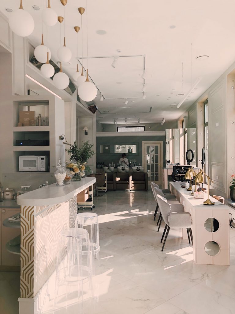 a large kitchen with white tables