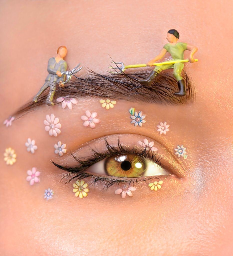 a close up of a person's eye with flowers on it