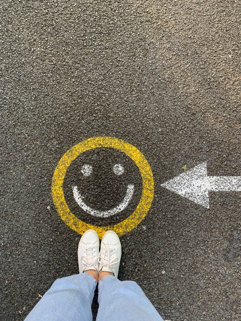 a person's foot with a yellow circle on it