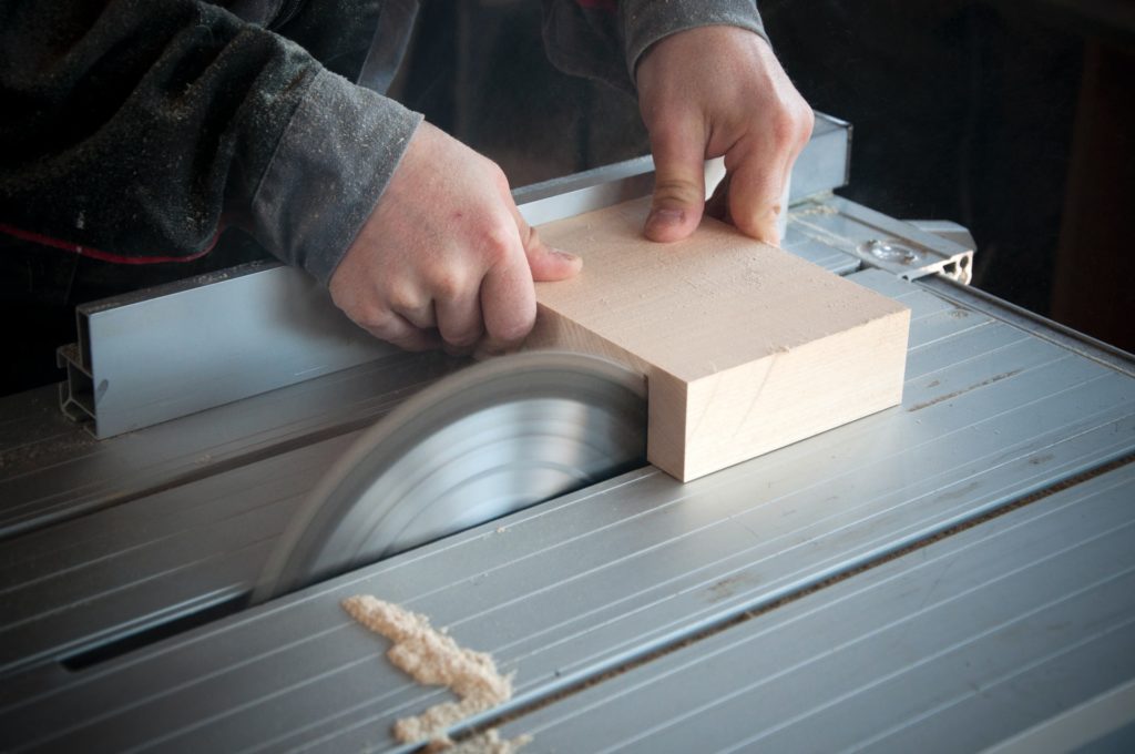 a person making a wooden block