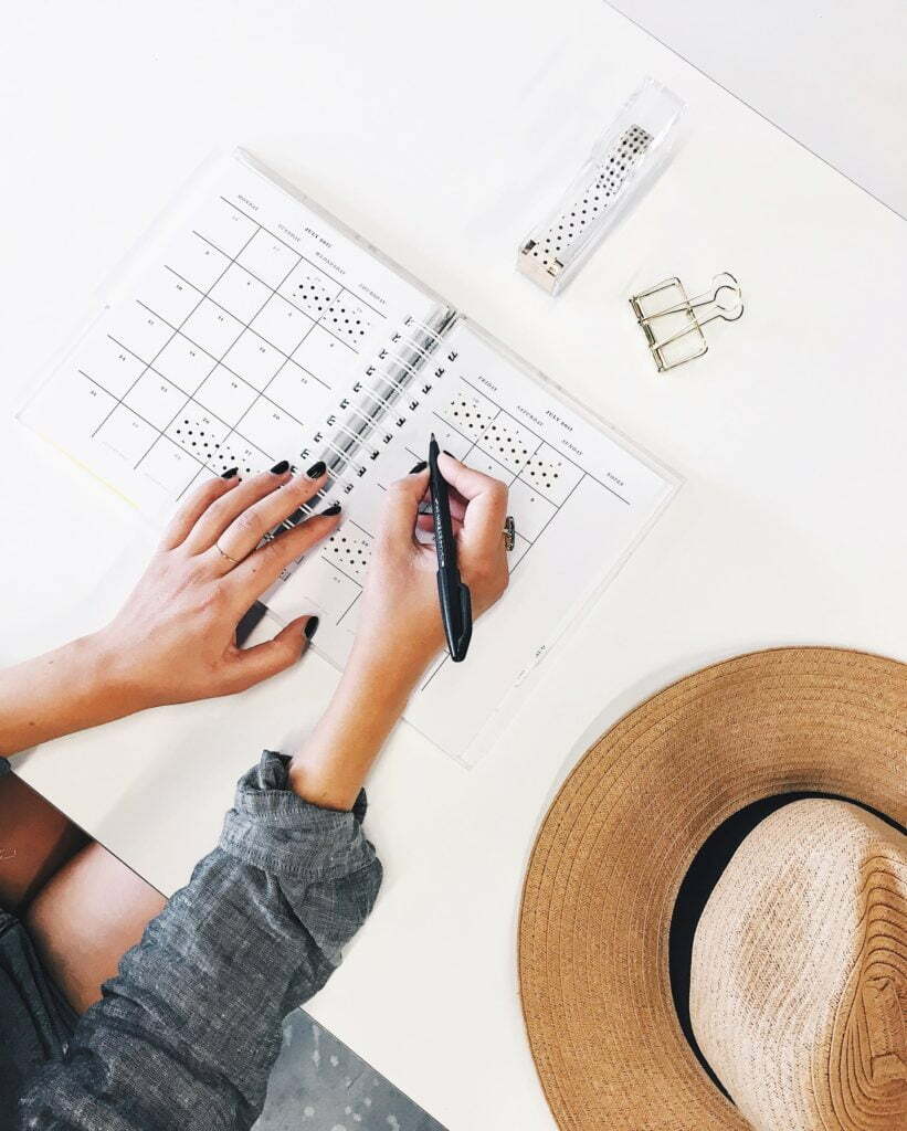 a person writing on a piece of paper