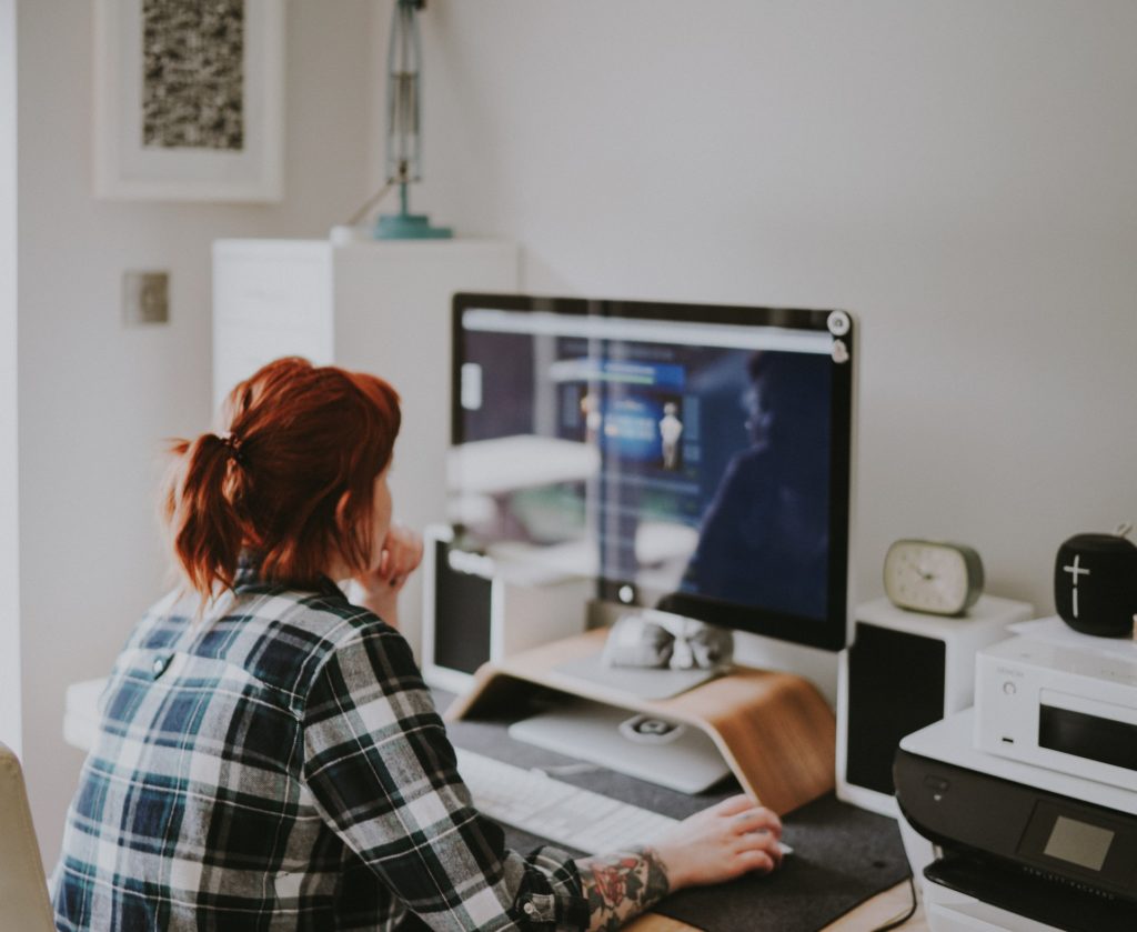 a person sitting in front of a computer