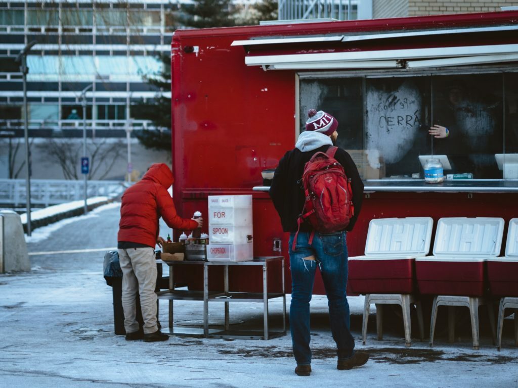 a couple of people standing outside a building