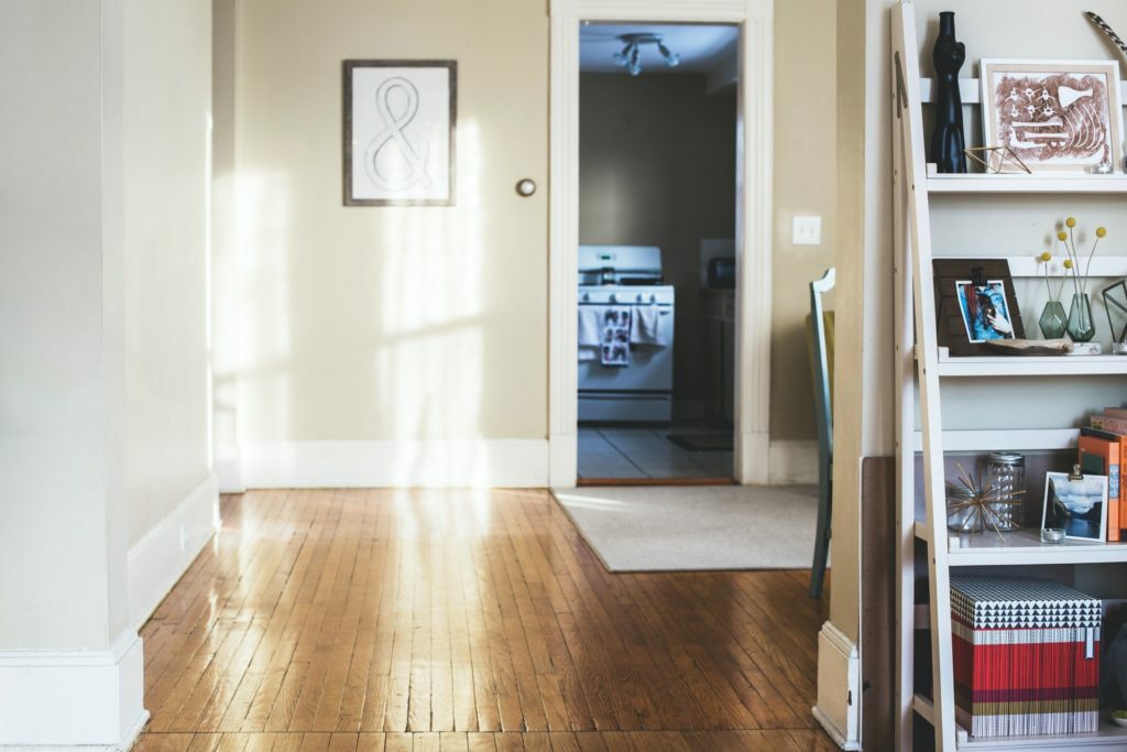 a hallway with a door and shelves