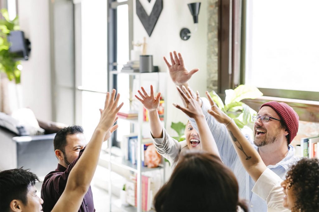 a group of people raising their hands