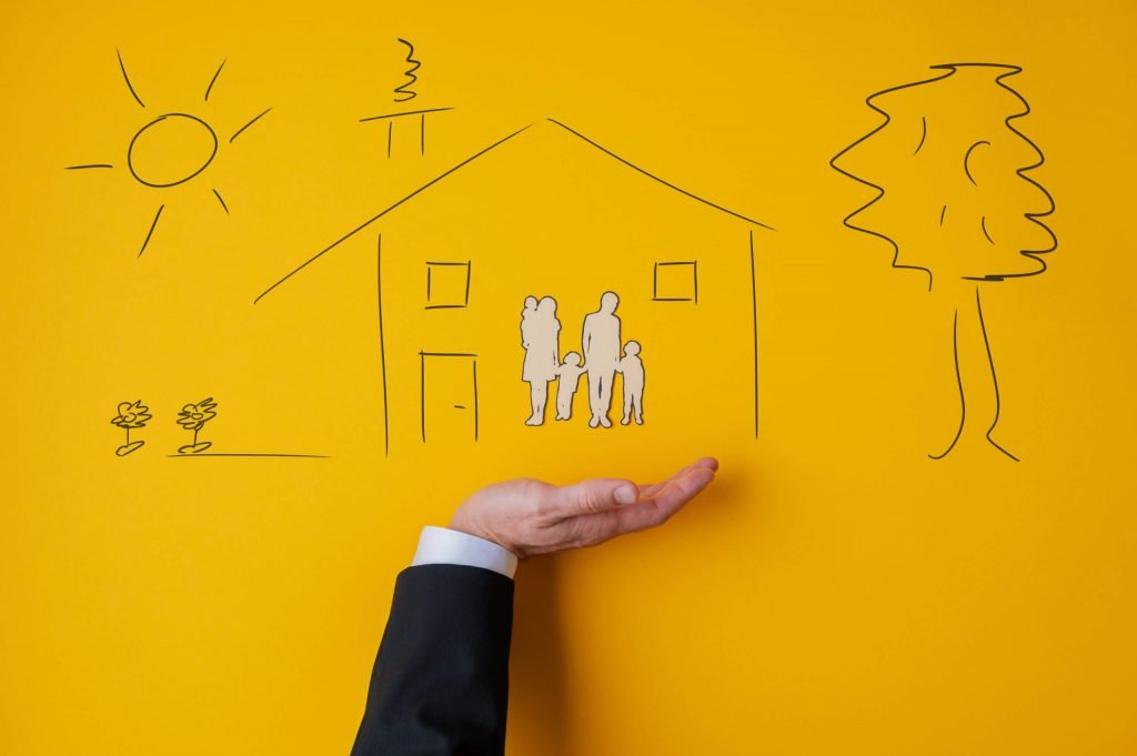 a person's hand pointing at a drawing on a yellow wall