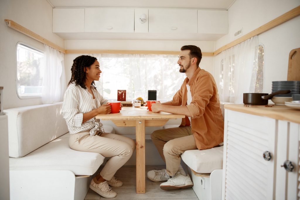 a man and a woman sitting at a table in a white room