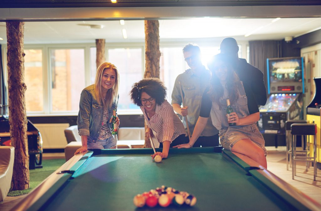 a group of people playing pool