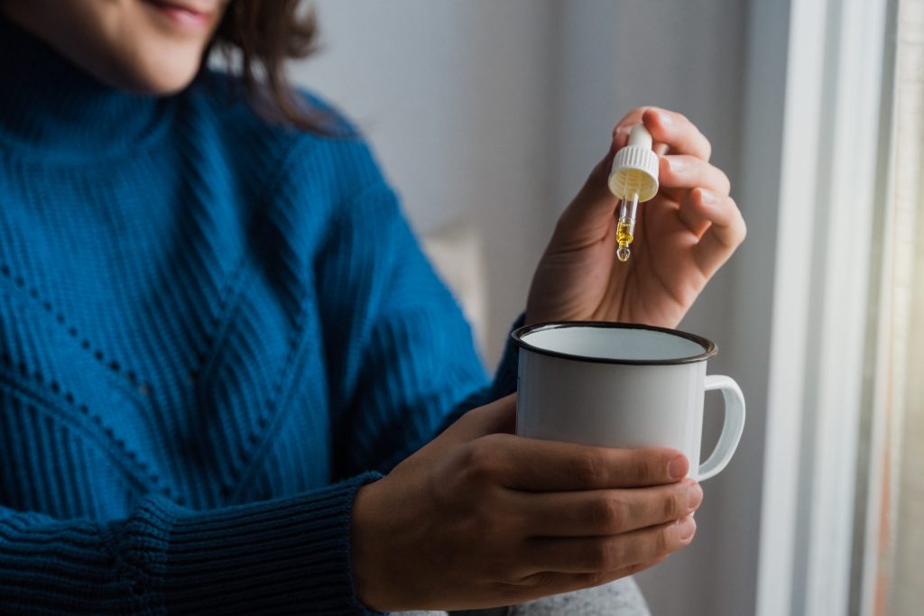 a woman holding a cup of coffee