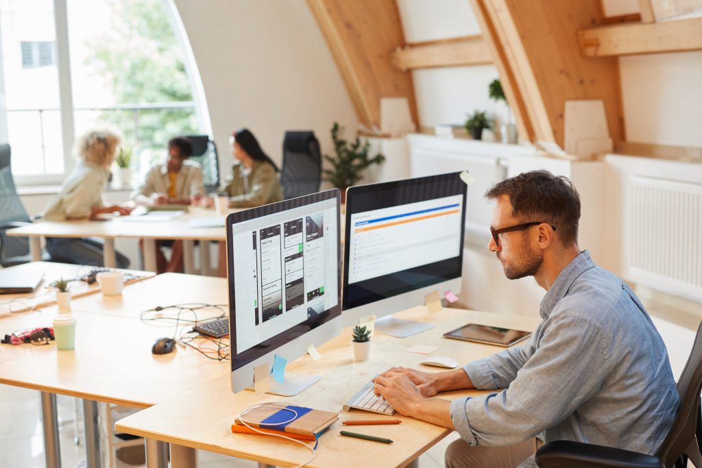 a man sitting at a table with a computer