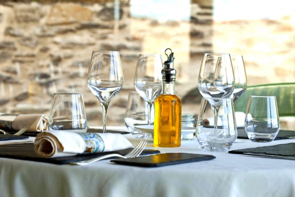 a table with wine glasses and bottles