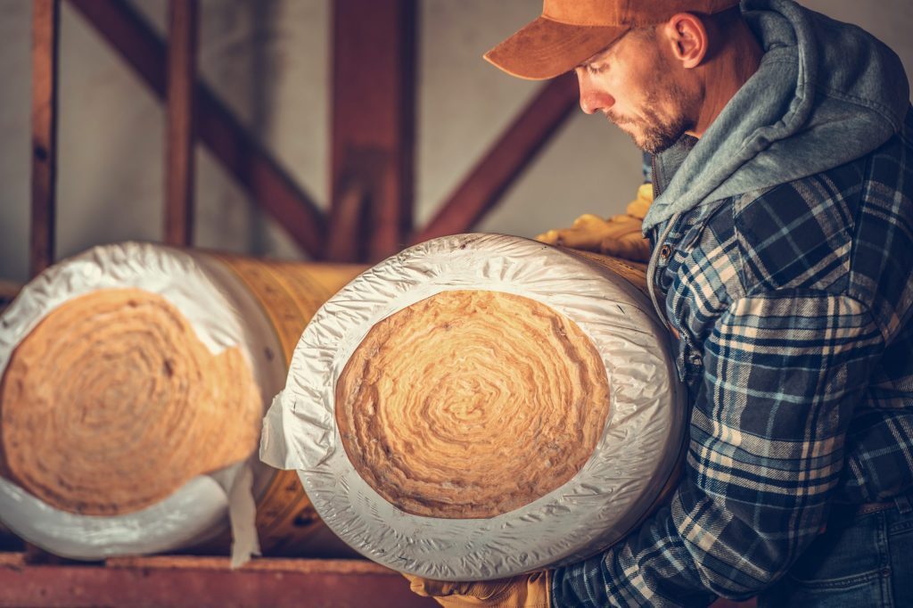 a man looking at a stack of coconuts