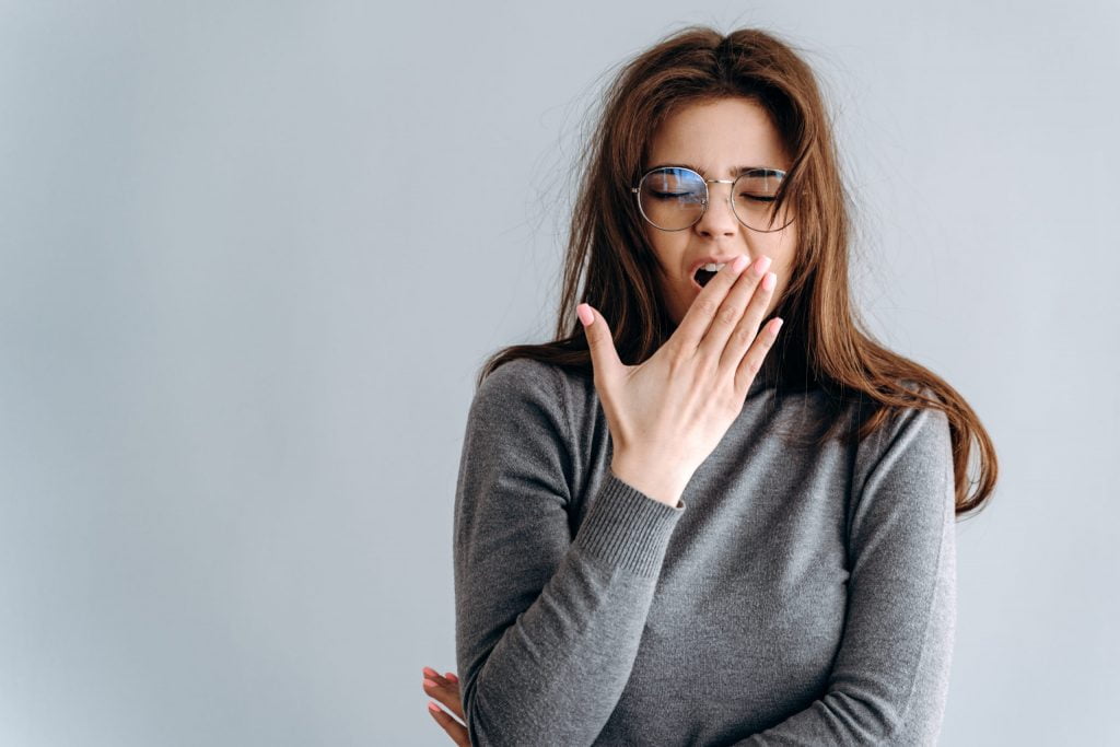 a woman with her hand on her face