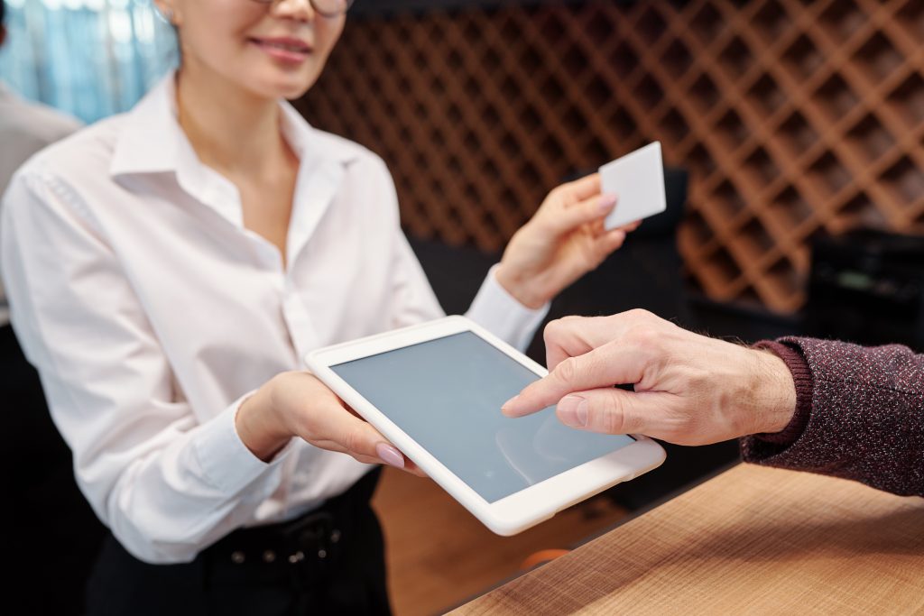 Hand of mature businessman pointing at tablet display to put his signature