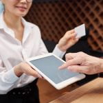 Hand of mature businessman pointing at tablet display to put his signature