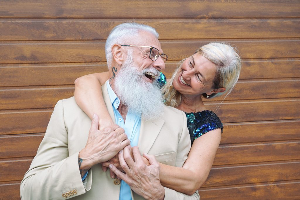 Happy fashion seniors couple embracing outdoor