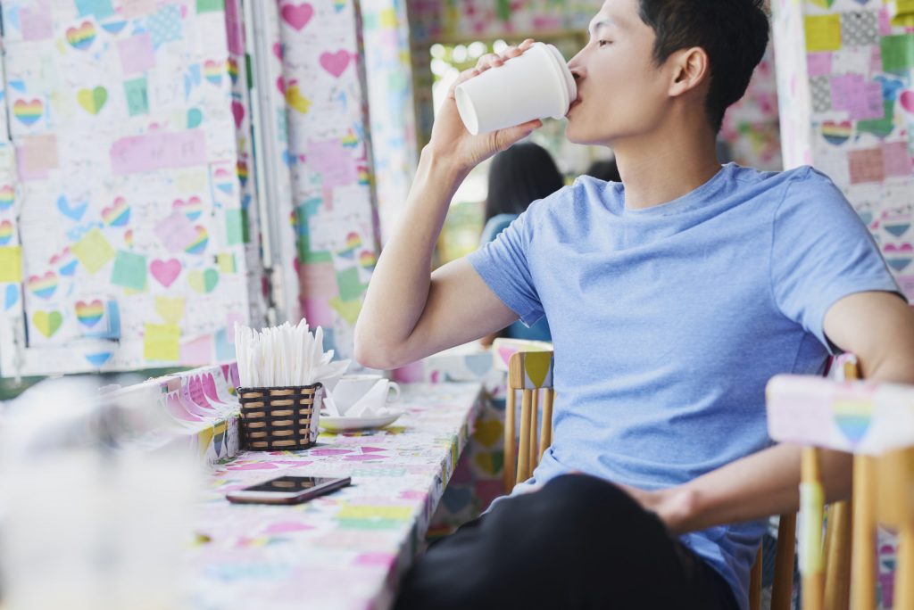 Vietnamese man drinking coffee in a cafe