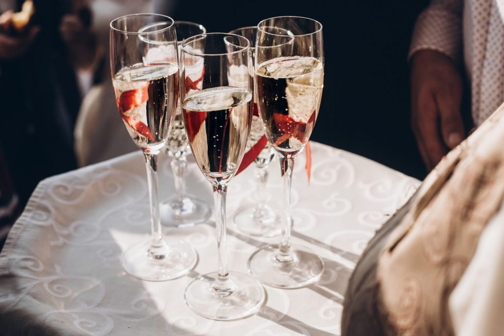 champagne glasses on tray at wedding reception       utc scaled