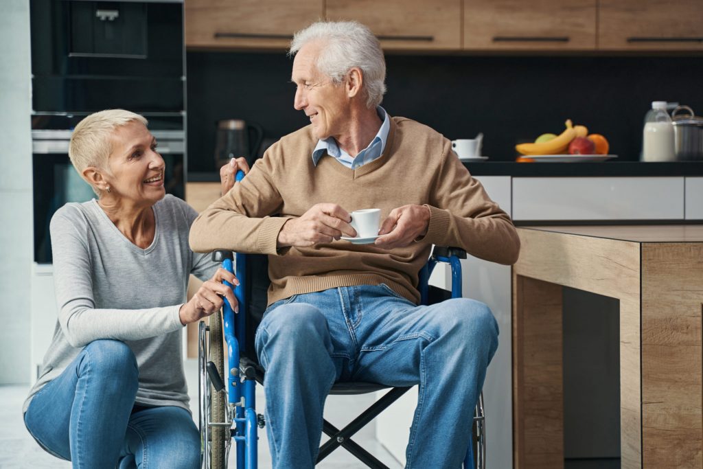 pleased aged woman talking with her disabled man       utc scaled