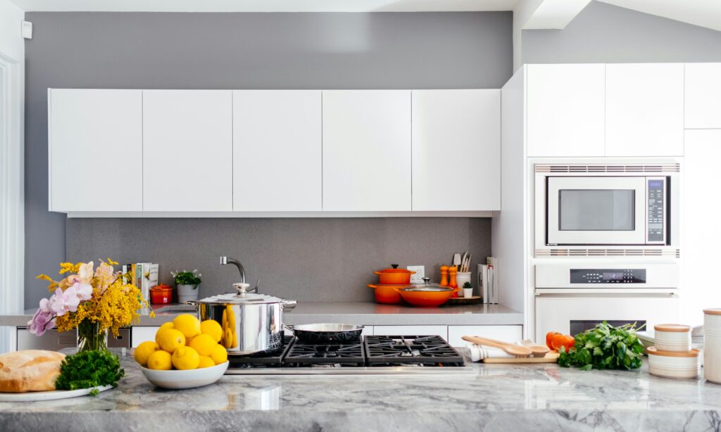 a kitchen with white cabinets and a stove