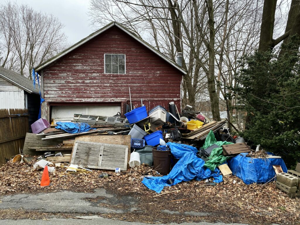 a pile of garbage outside of a house