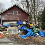 a pile of garbage outside of a house